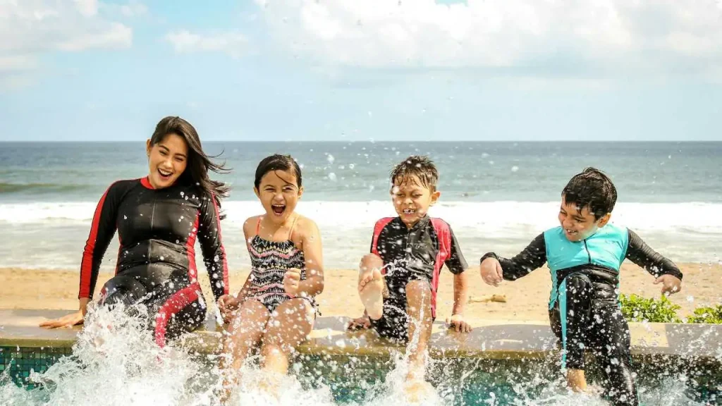 Mom and 3 kids in a pool