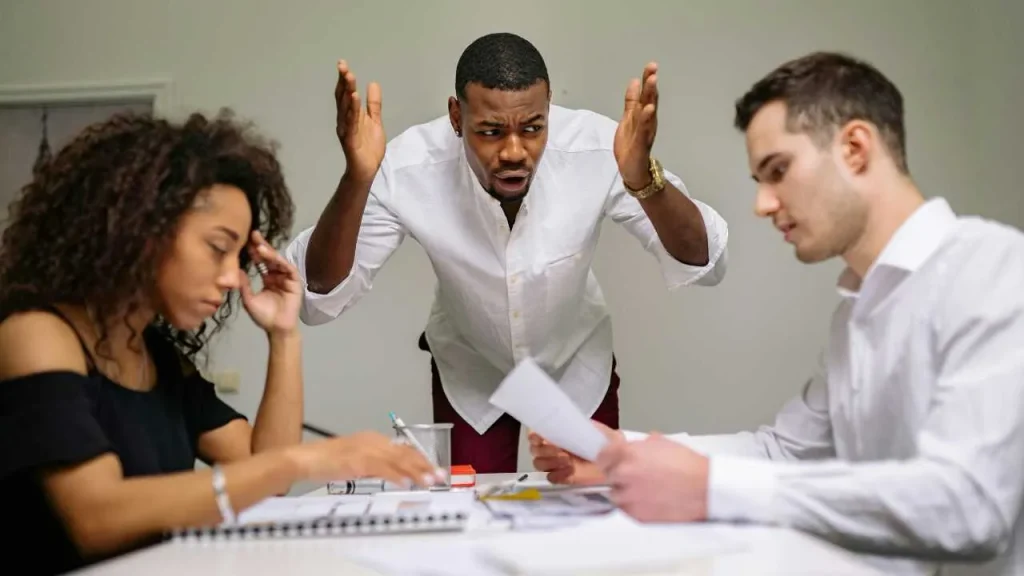 A man settling conflict between two person. Conflict resolution as one of the tips for effective communication.