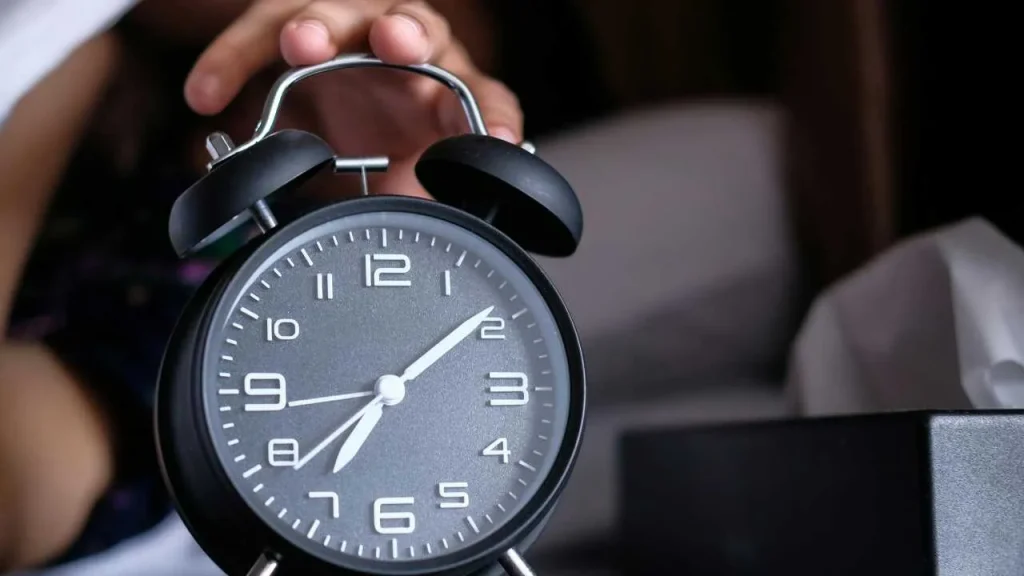 Avoid snoozing your alarm clock as a tip to achieve productive morning routines