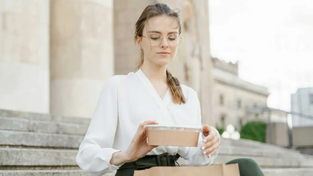 A lady mindfully eating in a serene environment