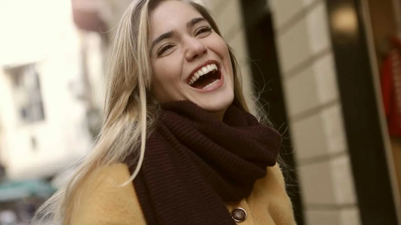 A joyful lady in a brown coat—representing a thankful heart