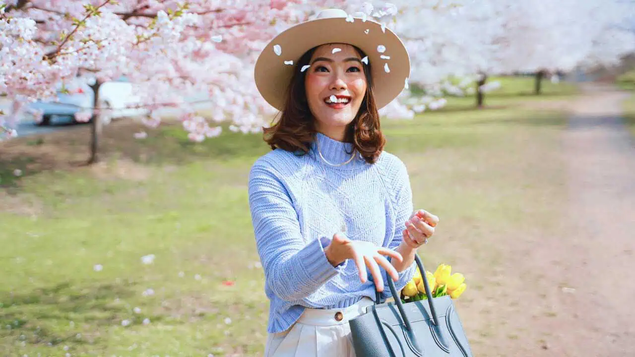 A lady on blue sleeves with a brown heart holding a blue bag—representing how to stop worrying and start living
