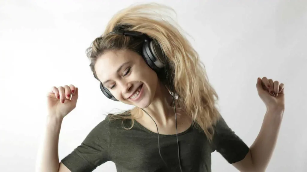 A lady dancing with a headphone on