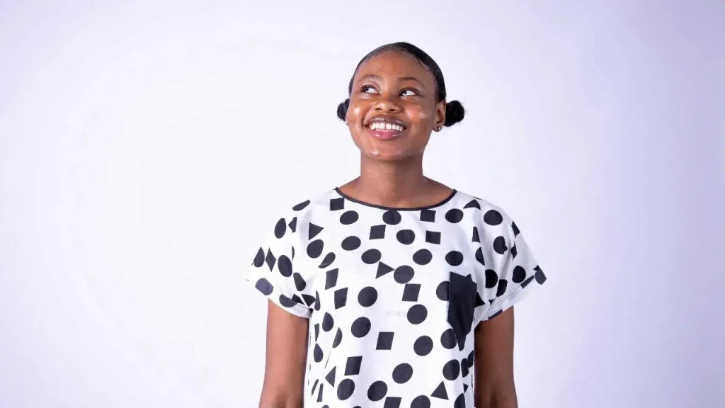 A lady smiling and thinking looking upwards