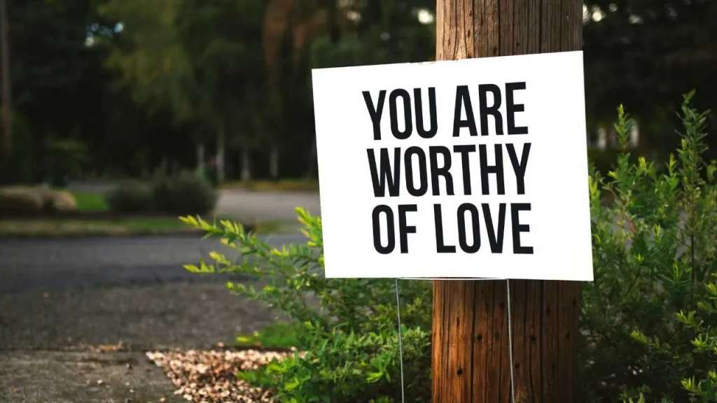 A sign board spelling out; you are worthy of love