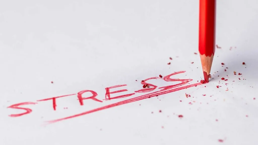The spelling of the word stress in colour red with a red pencil