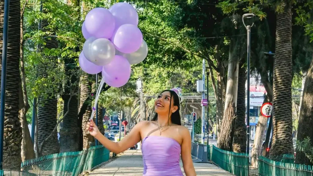 A lady on purple gown holding purple balloons representing self-love quotes