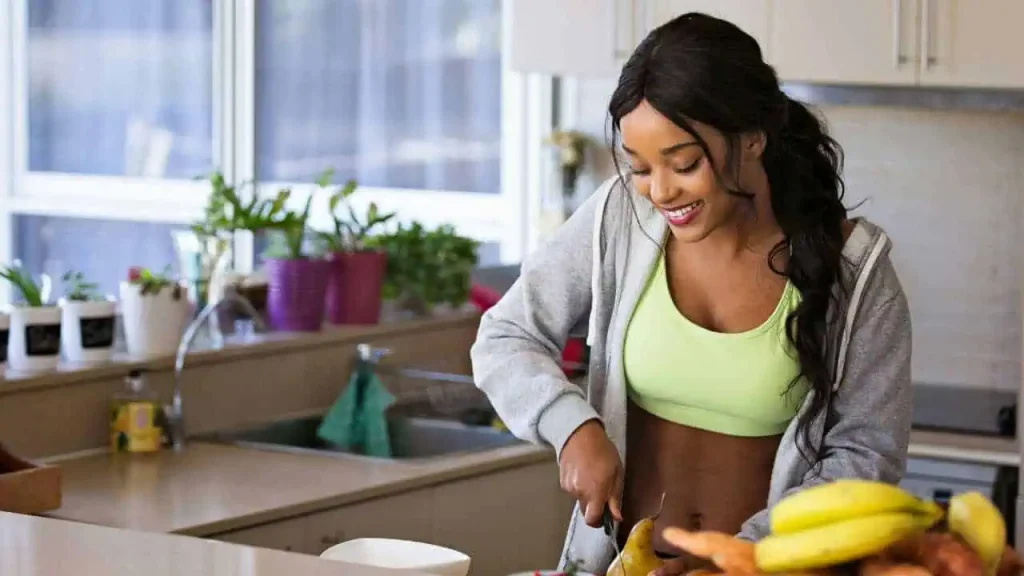 A lady cutting fruits on a table with a knife representing self-love quotes