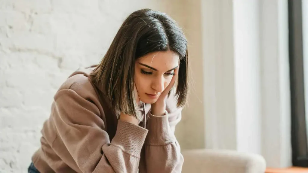 A sad lady on brown cardigan