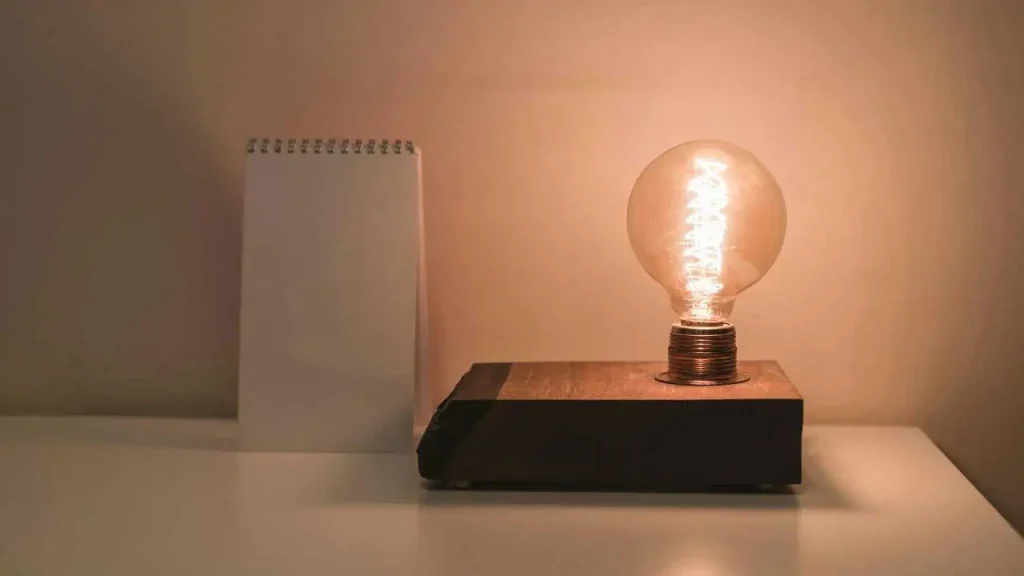 A shinning lamp beside a note book