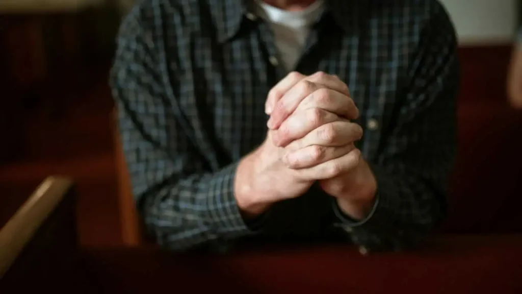 A man praying depicting i am the light of the world