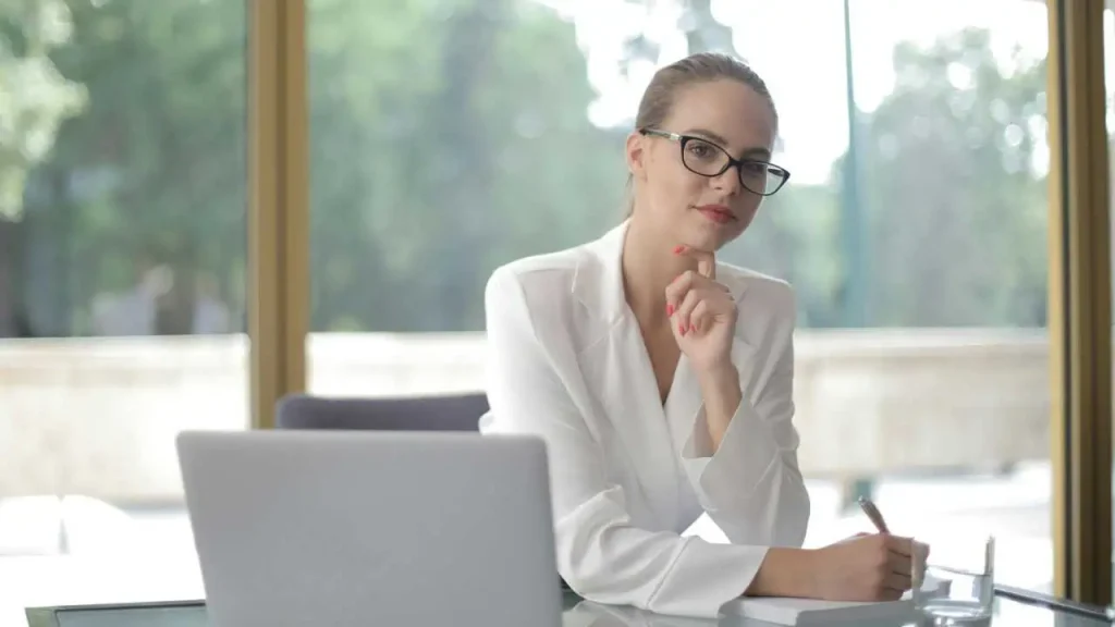 A lady on white sleeves writing depicting how to cultivate self acceptance