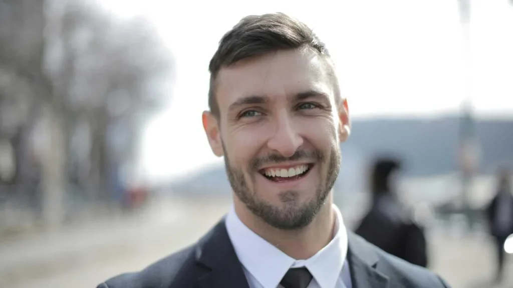 A joyful man on black suit