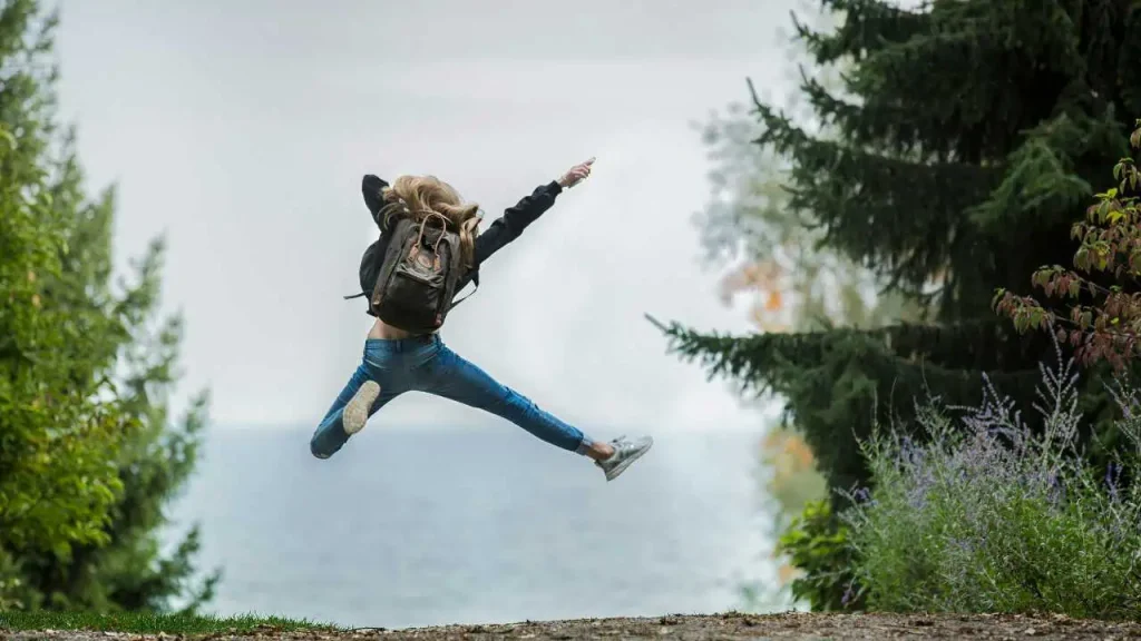 A person jumping into the air depicting how to enjoy life and be happy