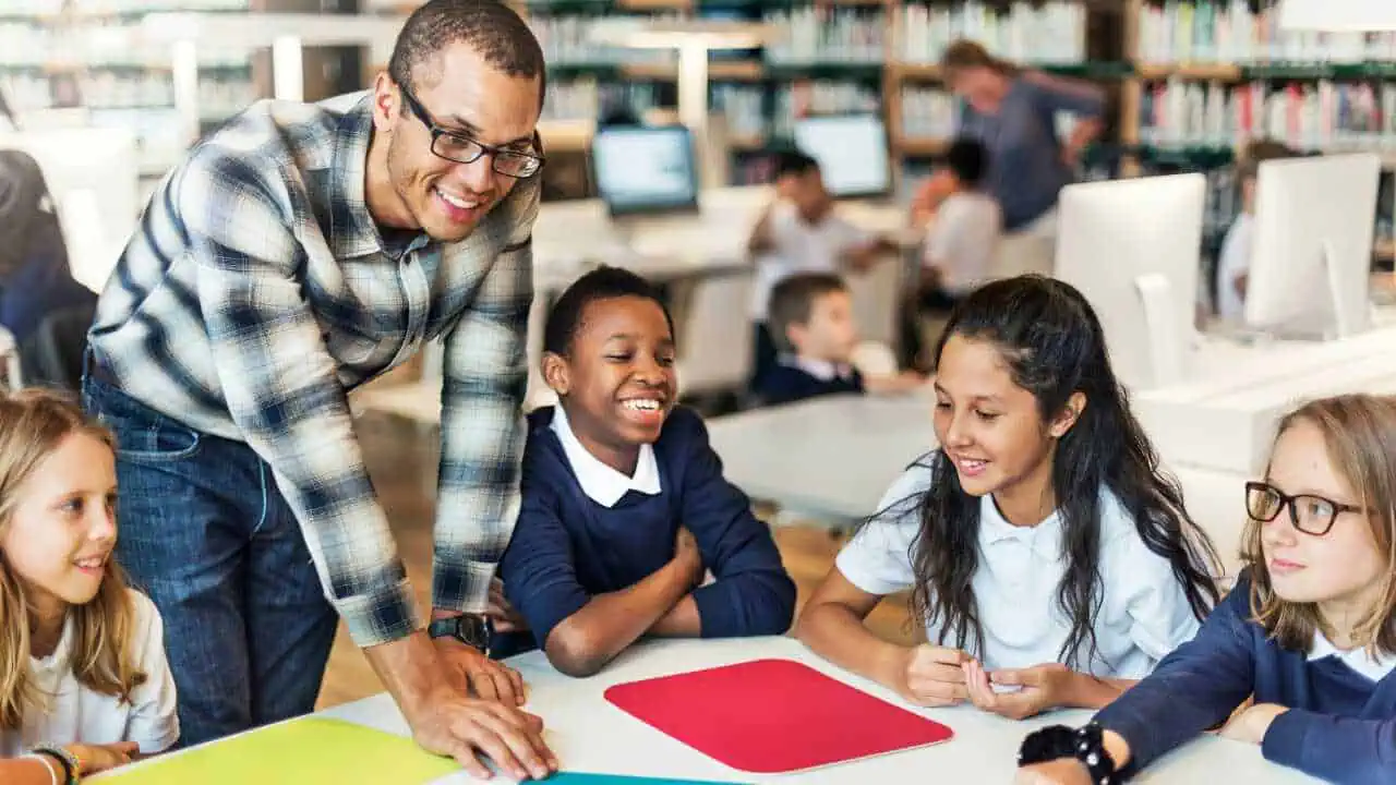 A male teacher instructing a group of student depicting Inspired teacher quotes