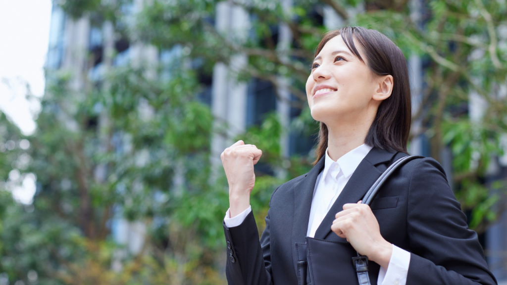 A joyful lady on black suit depicting ways to boost motivation