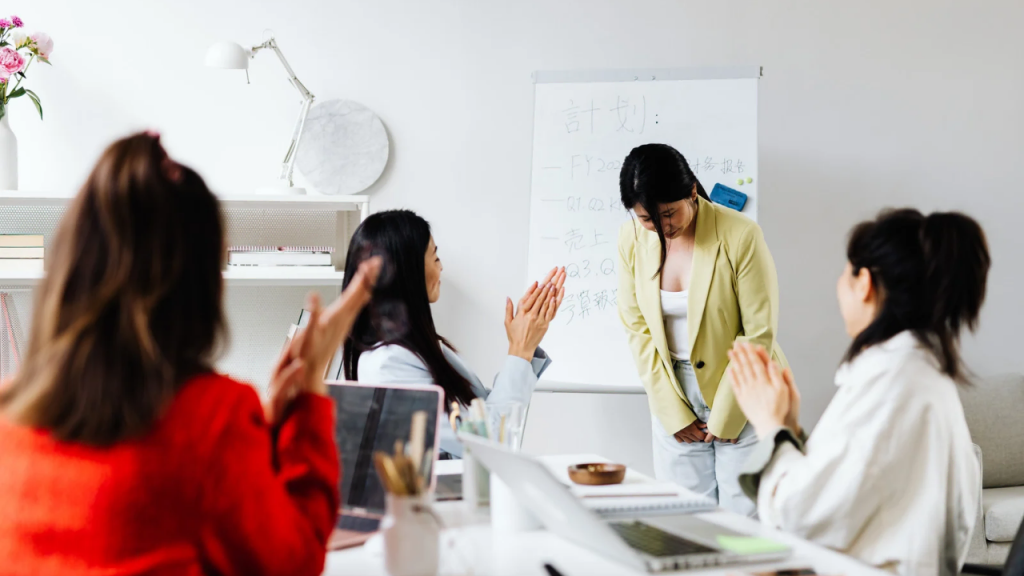 A lady receiving feedback during a board meeting depicting how to stop being a people pleaser