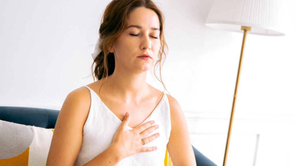 A lady on white in a mediative position depicting God is right beside you