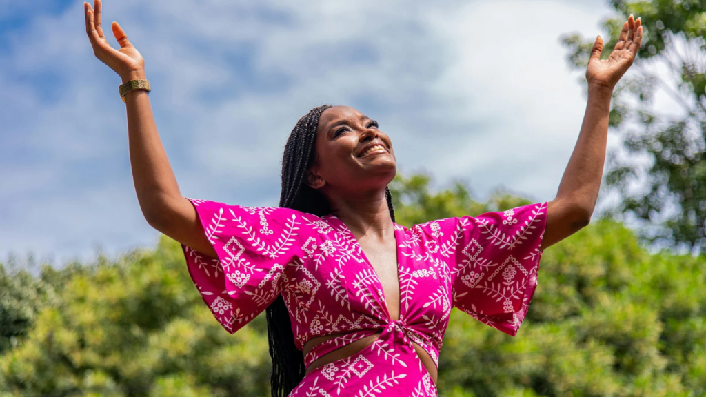 A lady raising her hands in worship