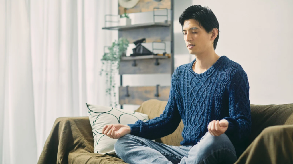 A young man on blue sleeves mediating depicting how to Journey Back to Your Strengths 