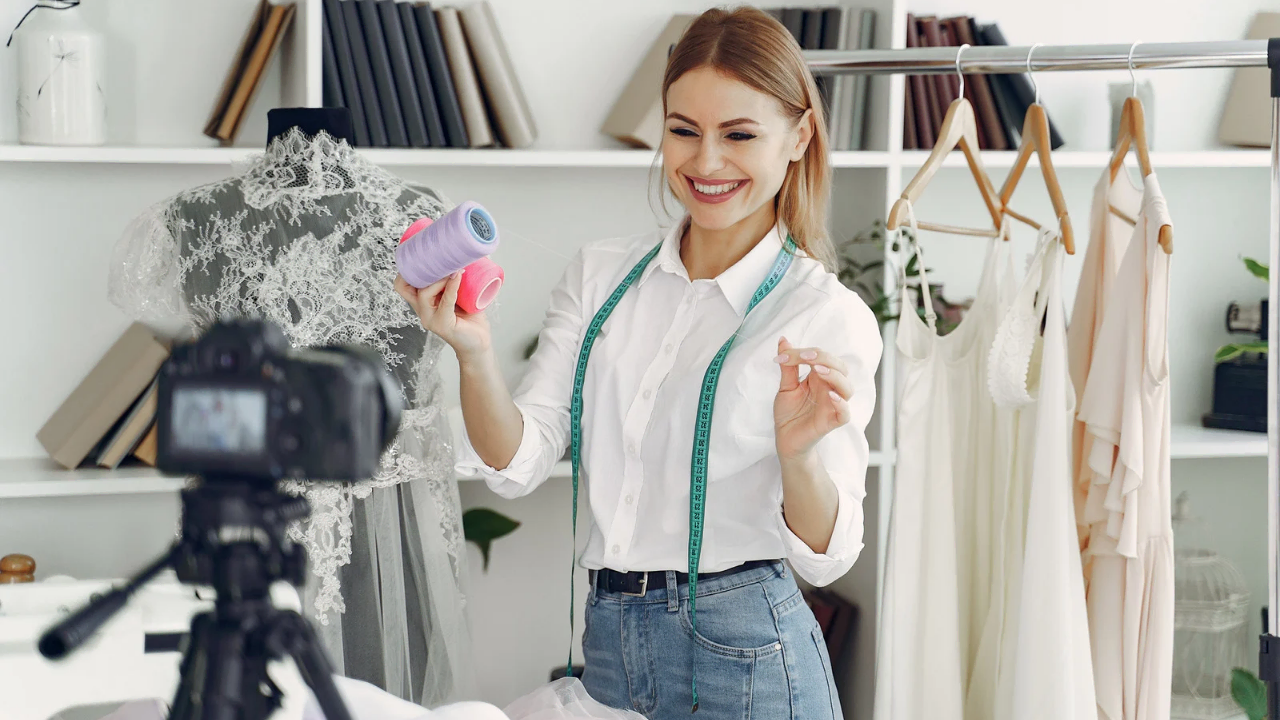 A lady recording in front of a camera holding wool depicting How to Build a Routine That Makes You Feel Good