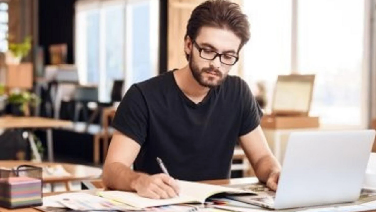 A man writing depicting how to build self discipline as a writer