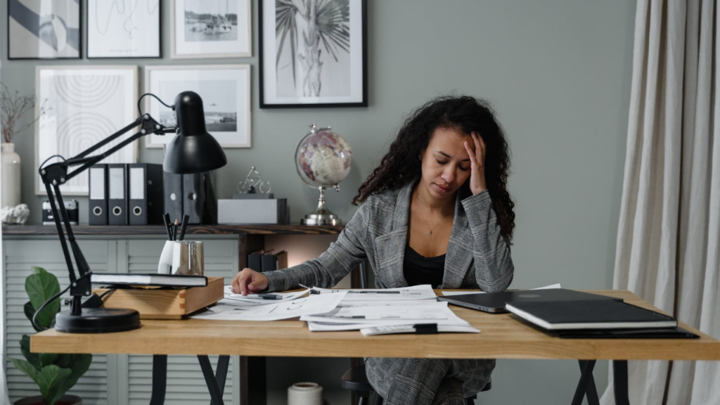 A hard working lady in her workspace depicting goal setting strategies.