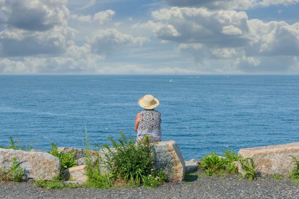 A person facing backwards to an wide sea